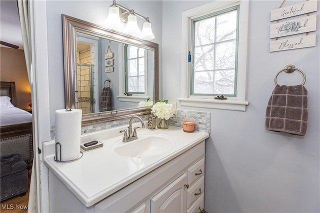 ensuite bathroom with ensuite bathroom, backsplash, and vanity