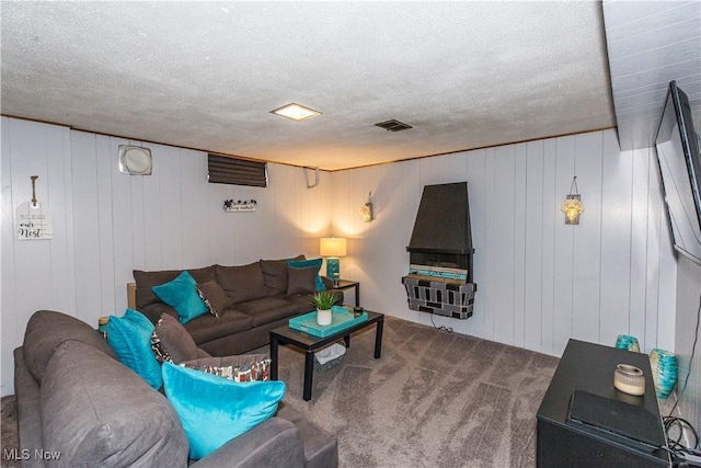 living room with visible vents and a textured ceiling