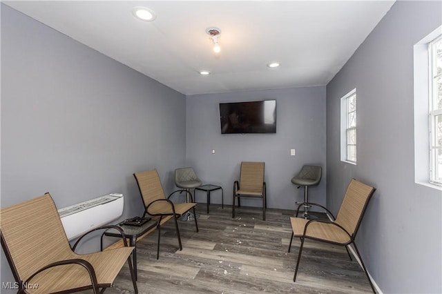 sitting room featuring baseboards, wood finished floors, and recessed lighting