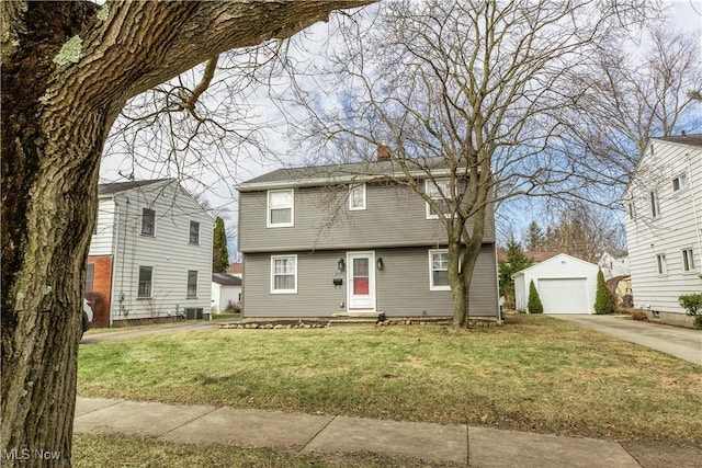 colonial home featuring central AC unit, an outdoor structure, a detached garage, concrete driveway, and a front lawn