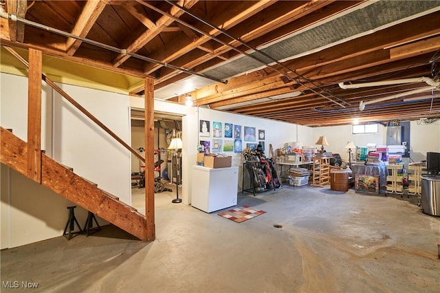 below grade area featuring washer / clothes dryer and refrigerator