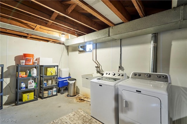 washroom featuring laundry area, a sink, and washing machine and clothes dryer