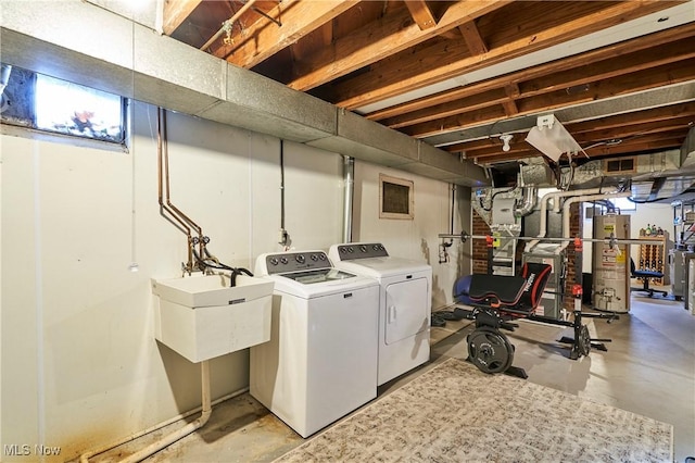 clothes washing area featuring laundry area, washer and dryer, and gas water heater