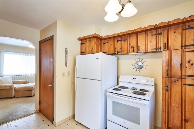 kitchen featuring brown cabinets, a notable chandelier, light floors, white appliances, and baseboards