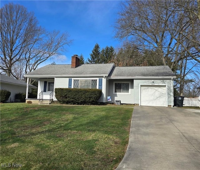 ranch-style house with an attached garage, driveway, roof with shingles, a chimney, and a front yard