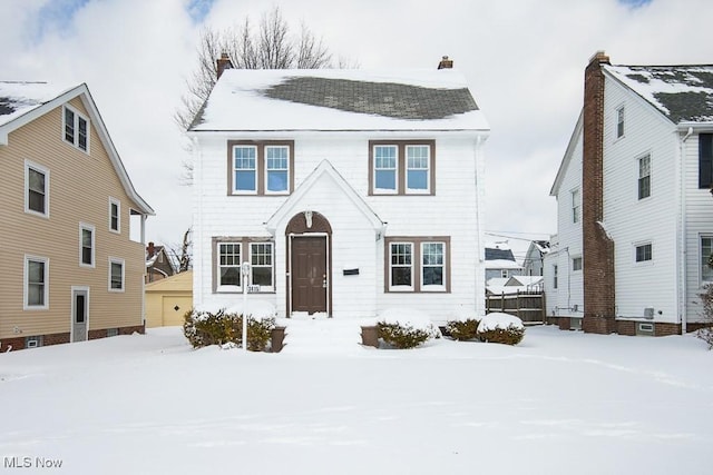 view of front of home featuring a garage and a chimney