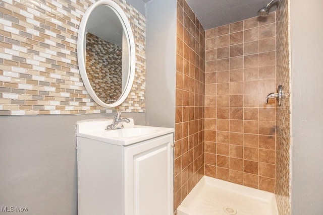 bathroom featuring a tile shower and vanity