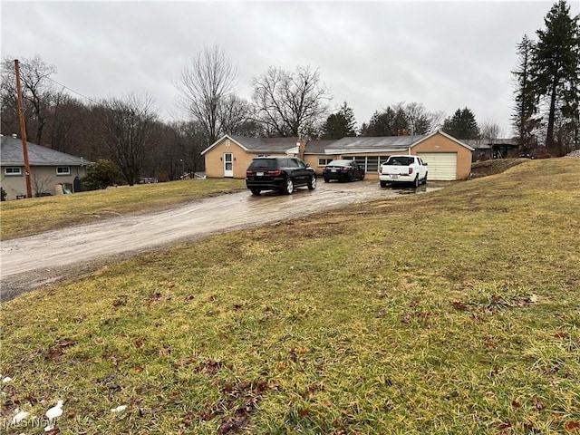 view of yard with driveway and a garage