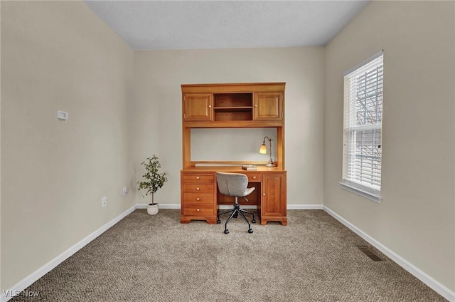 office space featuring visible vents, baseboards, and carpet flooring