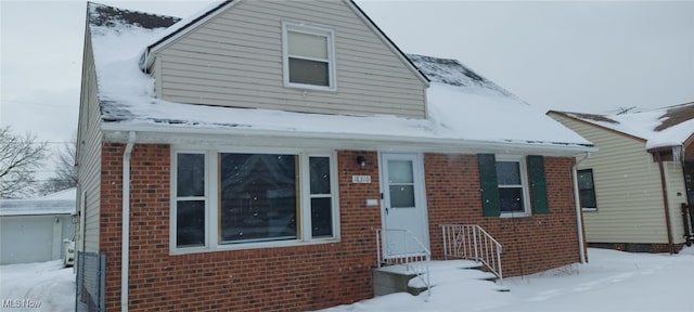 bungalow-style home with brick siding