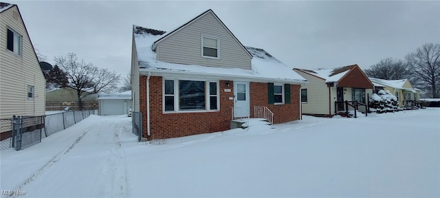 bungalow-style home with brick siding and fence