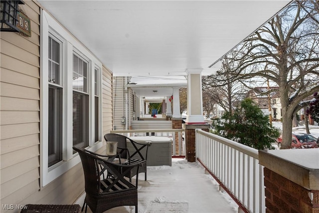 view of snow covered back of property