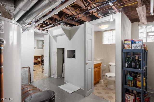 bathroom with gas water heater and toilet