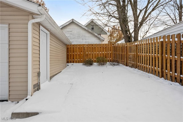 snowy yard featuring fence private yard