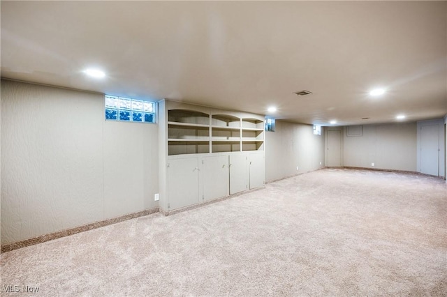 finished basement with recessed lighting, light carpet, and visible vents