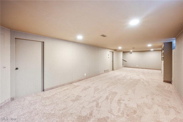 finished basement featuring recessed lighting, light carpet, and visible vents