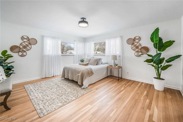 bedroom featuring light wood-type flooring and baseboards