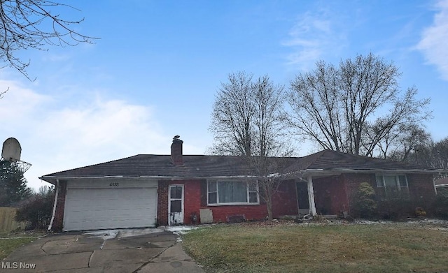 ranch-style house with an attached garage, brick siding, concrete driveway, a front lawn, and a chimney