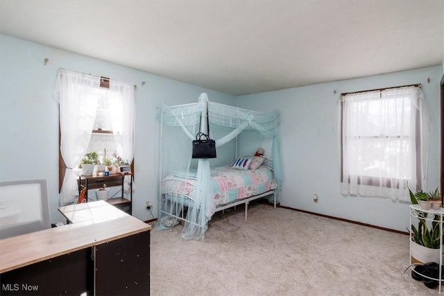 bedroom with carpet flooring and baseboards