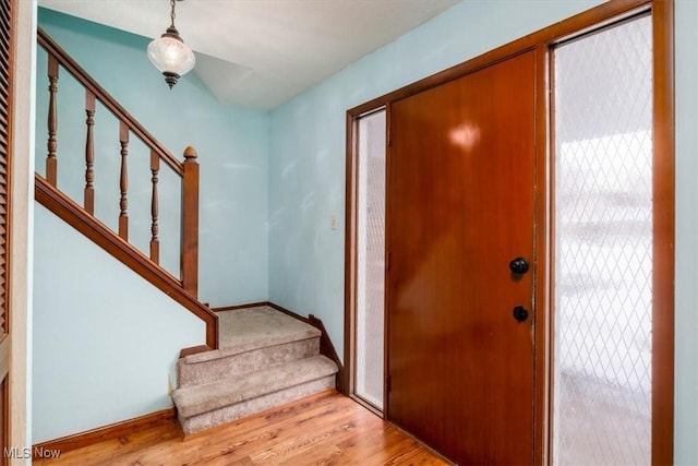 foyer with stairs and light wood-style flooring