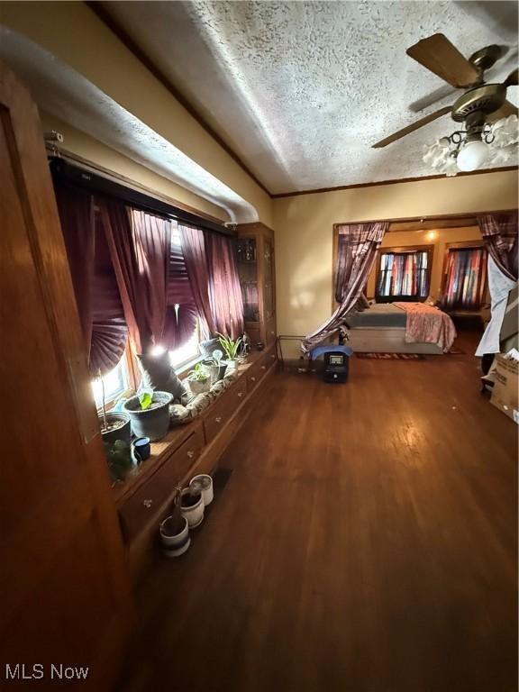 unfurnished bedroom with a textured ceiling and wood finished floors