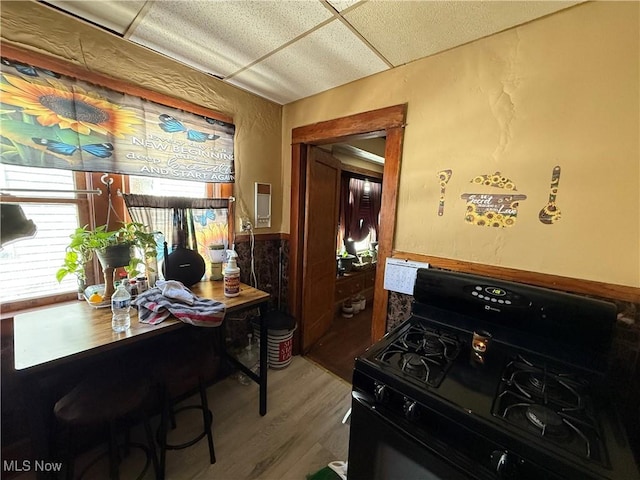 office featuring a wainscoted wall and wood finished floors