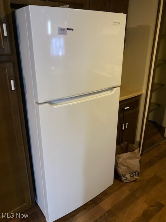 room details with dark wood-style flooring and freestanding refrigerator