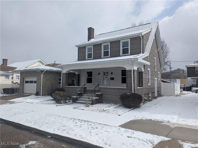 view of front of property featuring covered porch, a chimney, and an attached garage