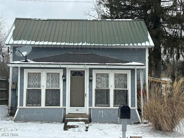 view of front of home featuring entry steps and metal roof