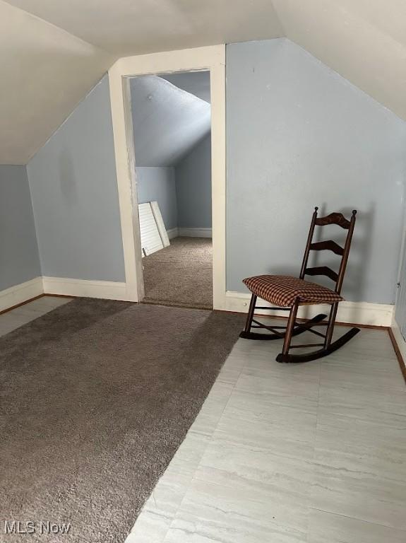 bonus room featuring vaulted ceiling, carpet floors, and baseboards