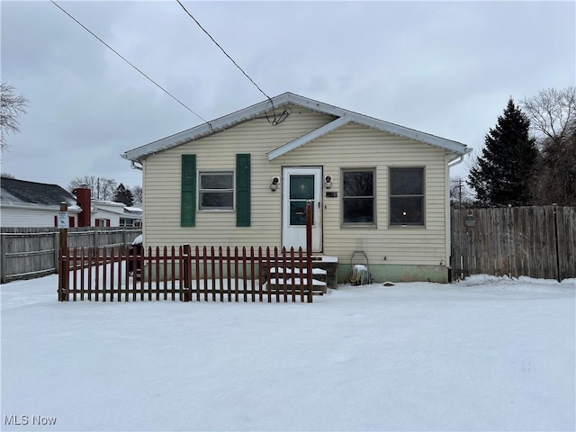 bungalow-style house featuring entry steps and fence