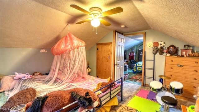 carpeted bedroom with a ceiling fan, vaulted ceiling, and a textured ceiling