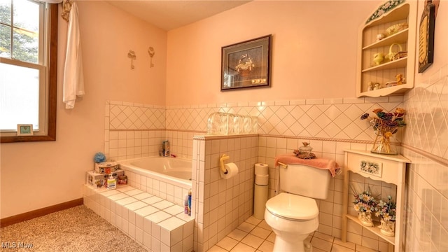 full bathroom with a garden tub, tile walls, toilet, baseboards, and tile patterned floors