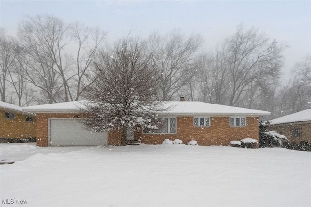 single story home with a garage and brick siding