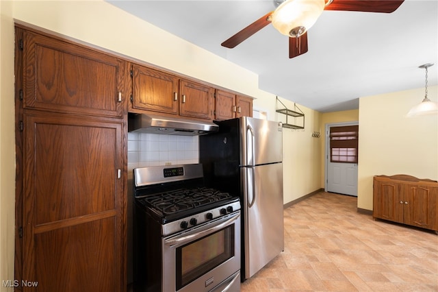 kitchen featuring decorative light fixtures, stainless steel appliances, backsplash, brown cabinetry, and under cabinet range hood