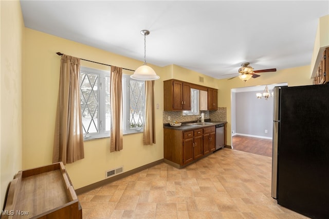 kitchen featuring tasteful backsplash, dark countertops, visible vents, appliances with stainless steel finishes, and baseboards