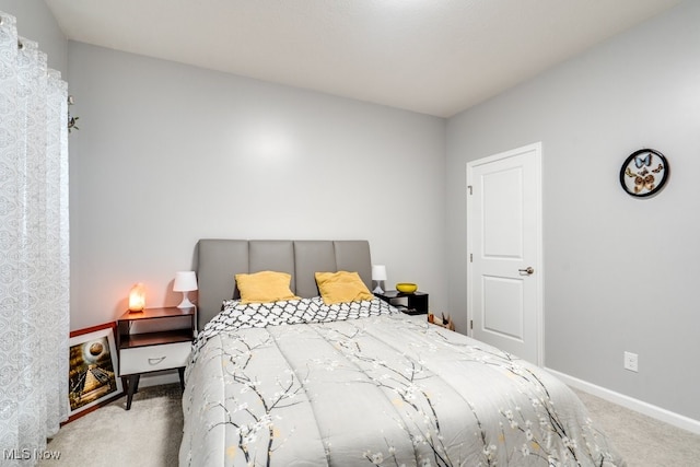 bedroom featuring carpet floors and baseboards