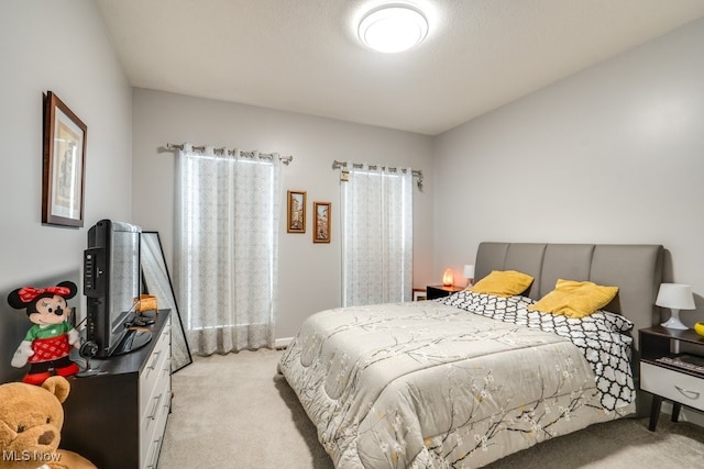 bedroom featuring light colored carpet