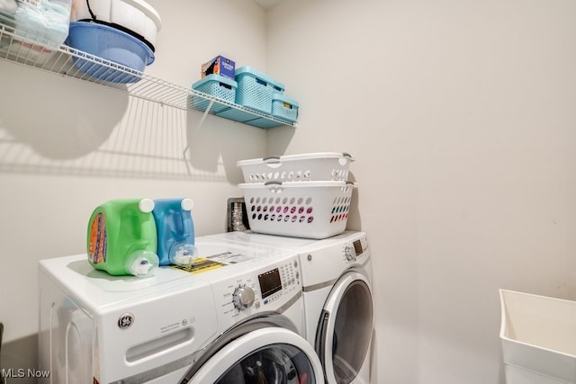 washroom featuring laundry area and separate washer and dryer