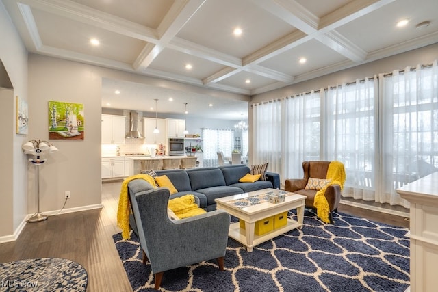 living area featuring an inviting chandelier, dark wood-style flooring, coffered ceiling, and beamed ceiling