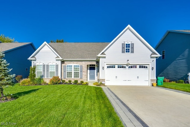 view of front of home featuring driveway, stone siding, an attached garage, and a front yard