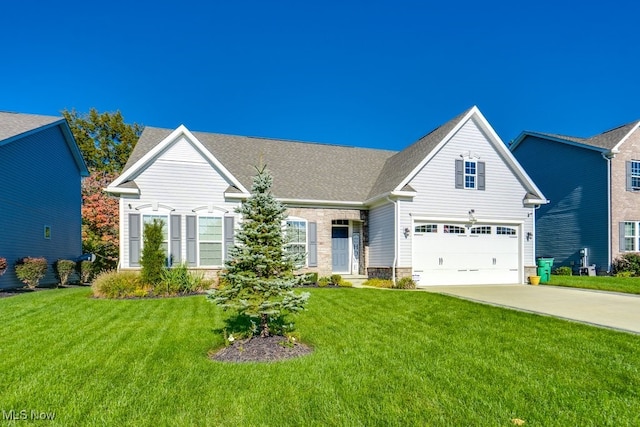 traditional-style home featuring an attached garage, driveway, and a front lawn