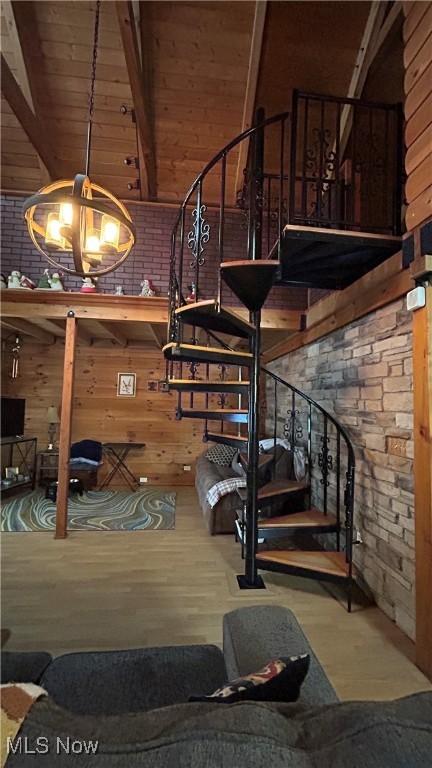 interior space featuring wood ceiling, wood walls, wood finished floors, and beam ceiling