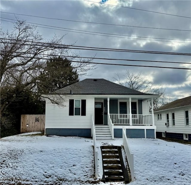 bungalow-style house with covered porch and a shingled roof