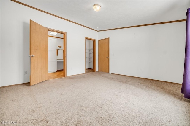 unfurnished bedroom with ornamental molding, carpet, and baseboards