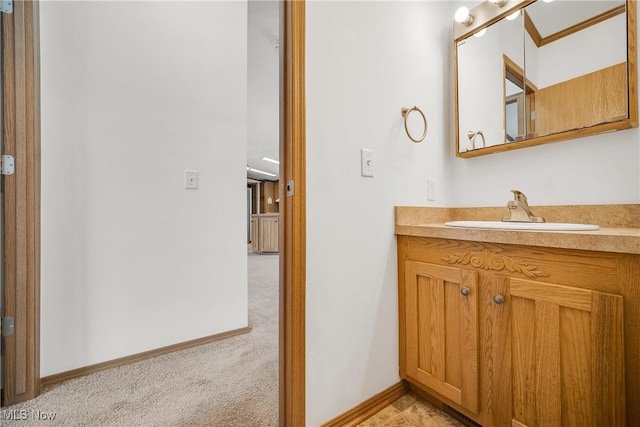 bathroom with crown molding, vanity, and baseboards