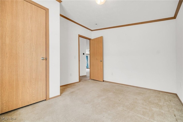 unfurnished bedroom featuring baseboards, carpet, and crown molding