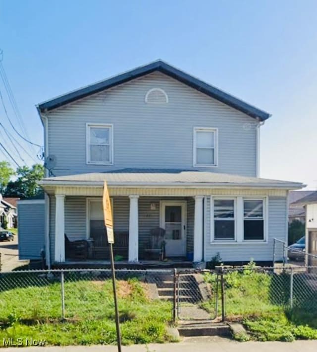 view of front of property featuring a porch and a fenced front yard