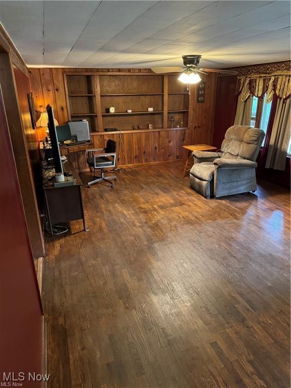 920 Caywood Rd, Marietta, OH 45750 - home office with built in features, wood walls, a ceiling fan, and dark wood-style flooring