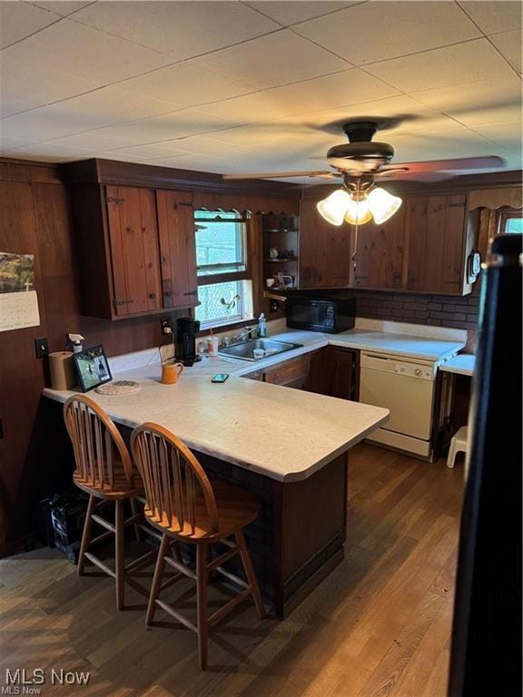 920 Caywood Rd, Marietta, OH 45750 - kitchen featuring a peninsula, black appliances, a kitchen bar, and light countertops